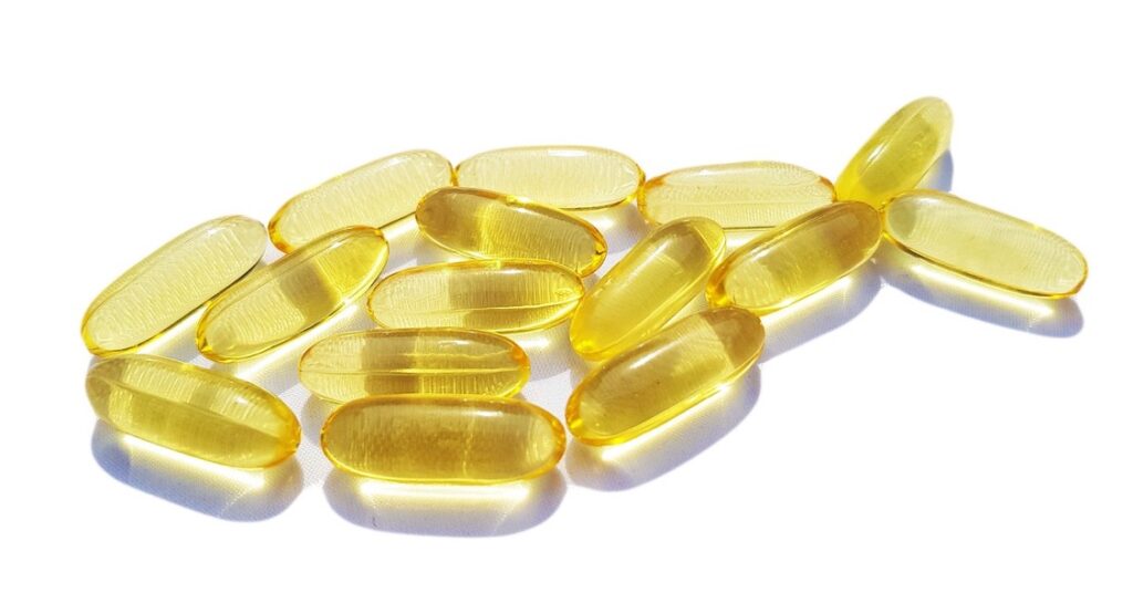 Omega-3 fatty acid supplements arranged in the shape of a fish