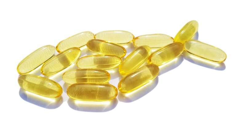 Omega-3 fatty acid supplements arranged in the shape of a fish
