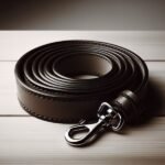 A leash is curled up on a wooden table