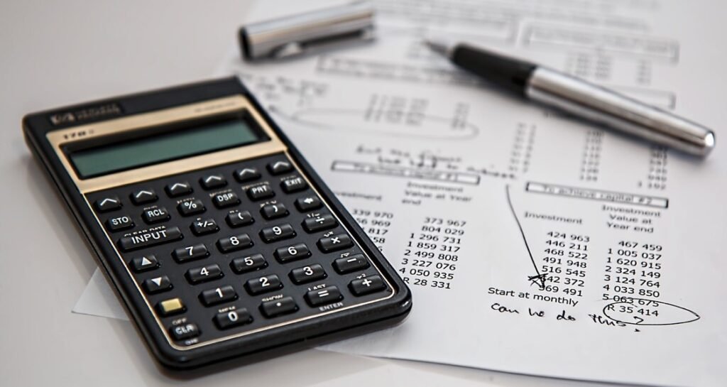 A calculator on top of a paper with numbers