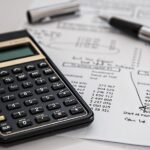 A calculator on top of a paper with numbers