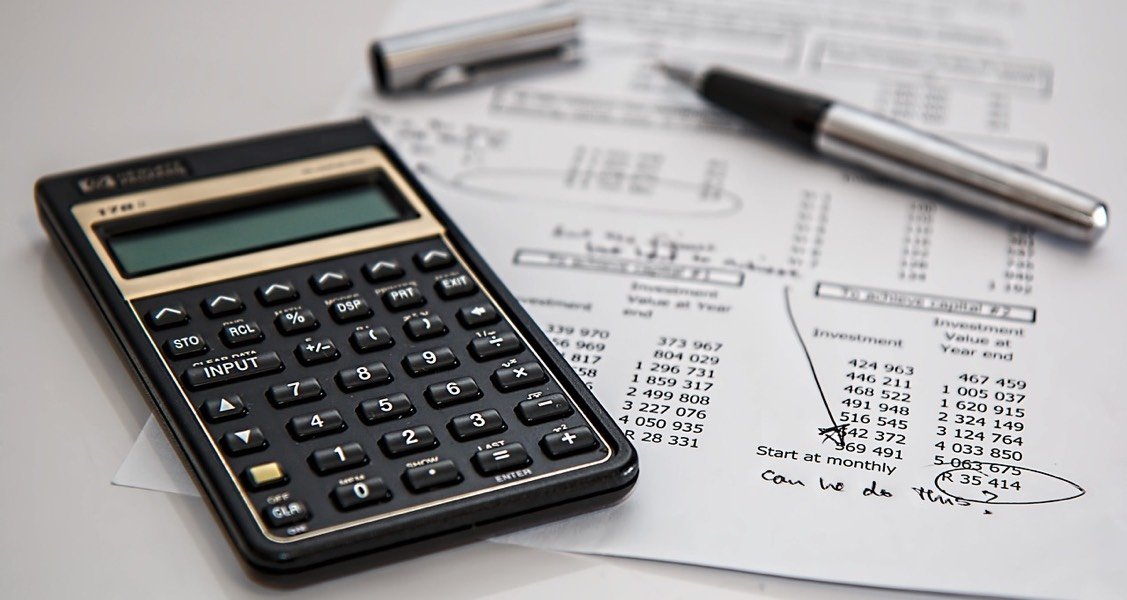 A calculator on top of a paper with numbers