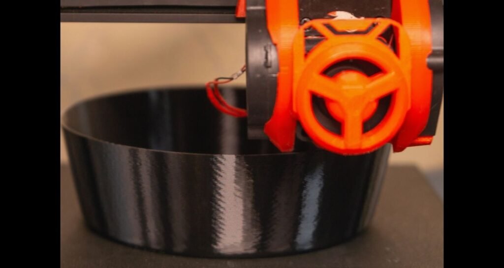 A 3D printer is printing a bowl