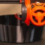 A 3D printer is printing a bowl
