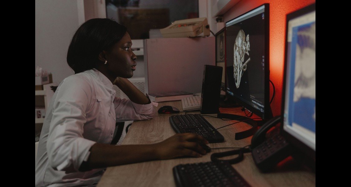 A woman is looking at scans of an animal