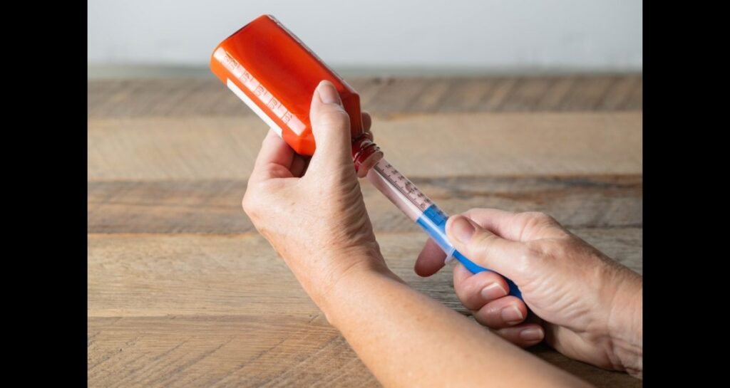 A liquid medication being pulled up in a syringe