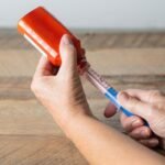 A liquid medication being pulled up in a syringe